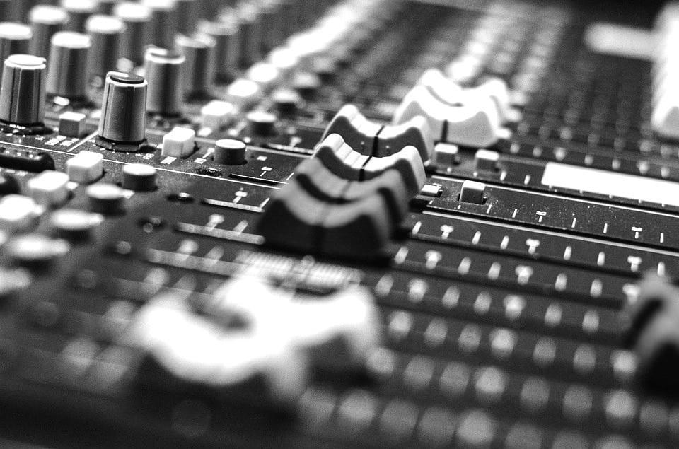 Audio Mixing Board Fader Shot Black and White with buttons and knobs audio production technical angle shot